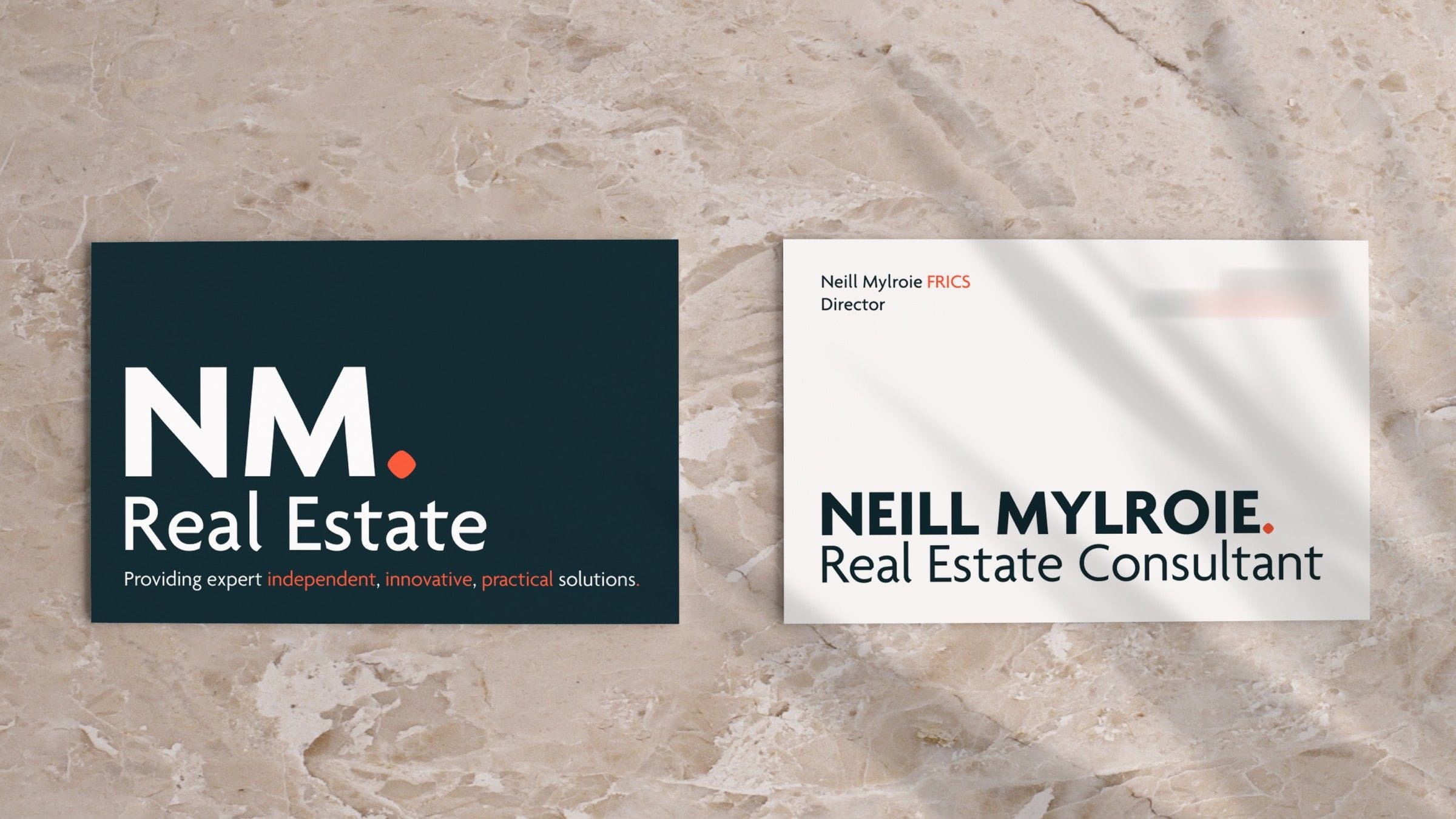 NM Real Estate business cards: the NM wordmark with a red full stop